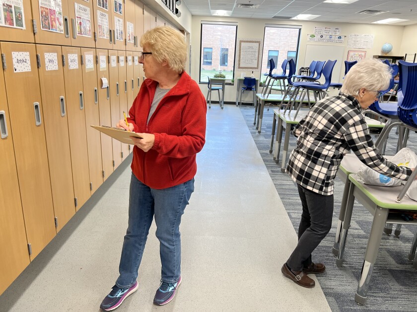 Volunteers from American Lutheran distribute Every Meal food bags to children at the Intermediate School in Worthington.