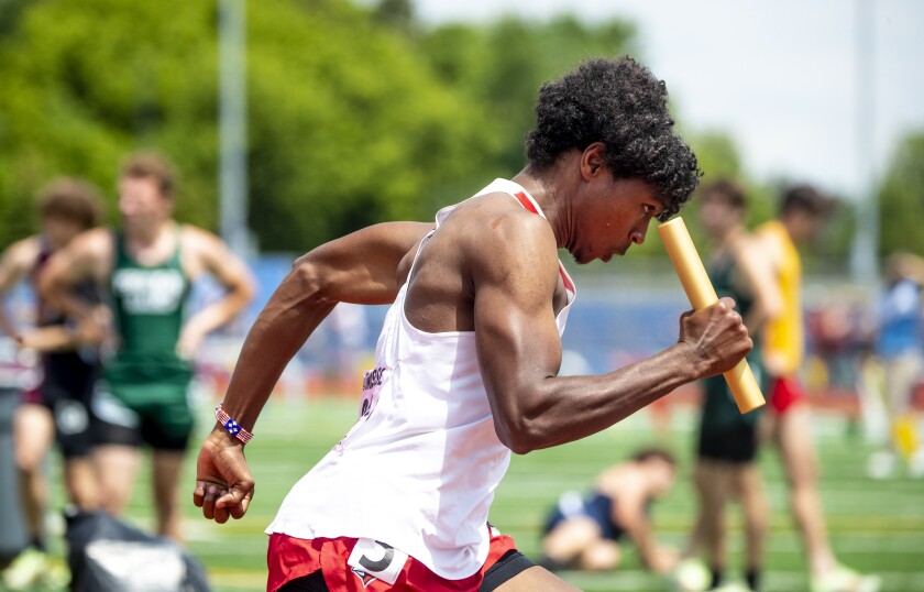 Hassennadif Hassen races down the track in the boys 4x400 during the Class AA state track and field championships at St. Michael on Saturday, June 11, 2022.