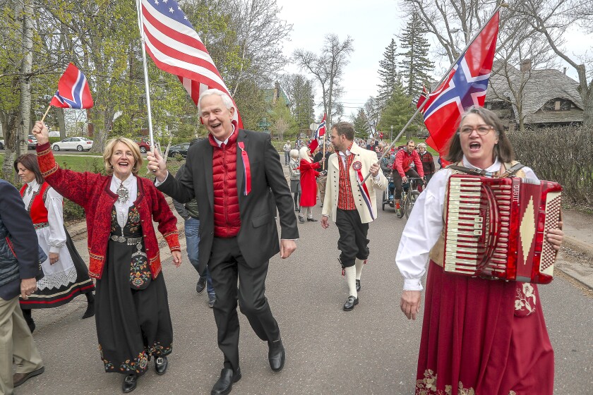 t051719 --- Clint Austin --- 051819.N.DNT.MAI.C01 --- Lise Lunge-Larsen (from left) Johan Bakken VII, Johan Bakken VIII and Arna Rennan march along 25th Avenue East in a parade with a group of Duluth families as they celebrate Syttende Mai for the 30th year in Duluth Friday afternoon. --- Clint Austin / caustin@duluthnews.com