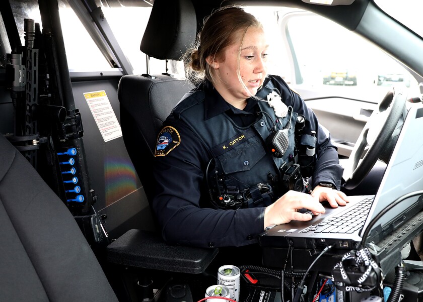 Duluth Police Officer Katie Catton logs into the computer in her squad car