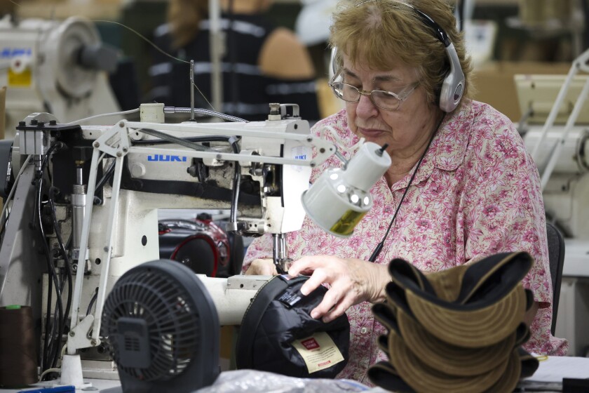 Wool caps with ear bands being made in factory