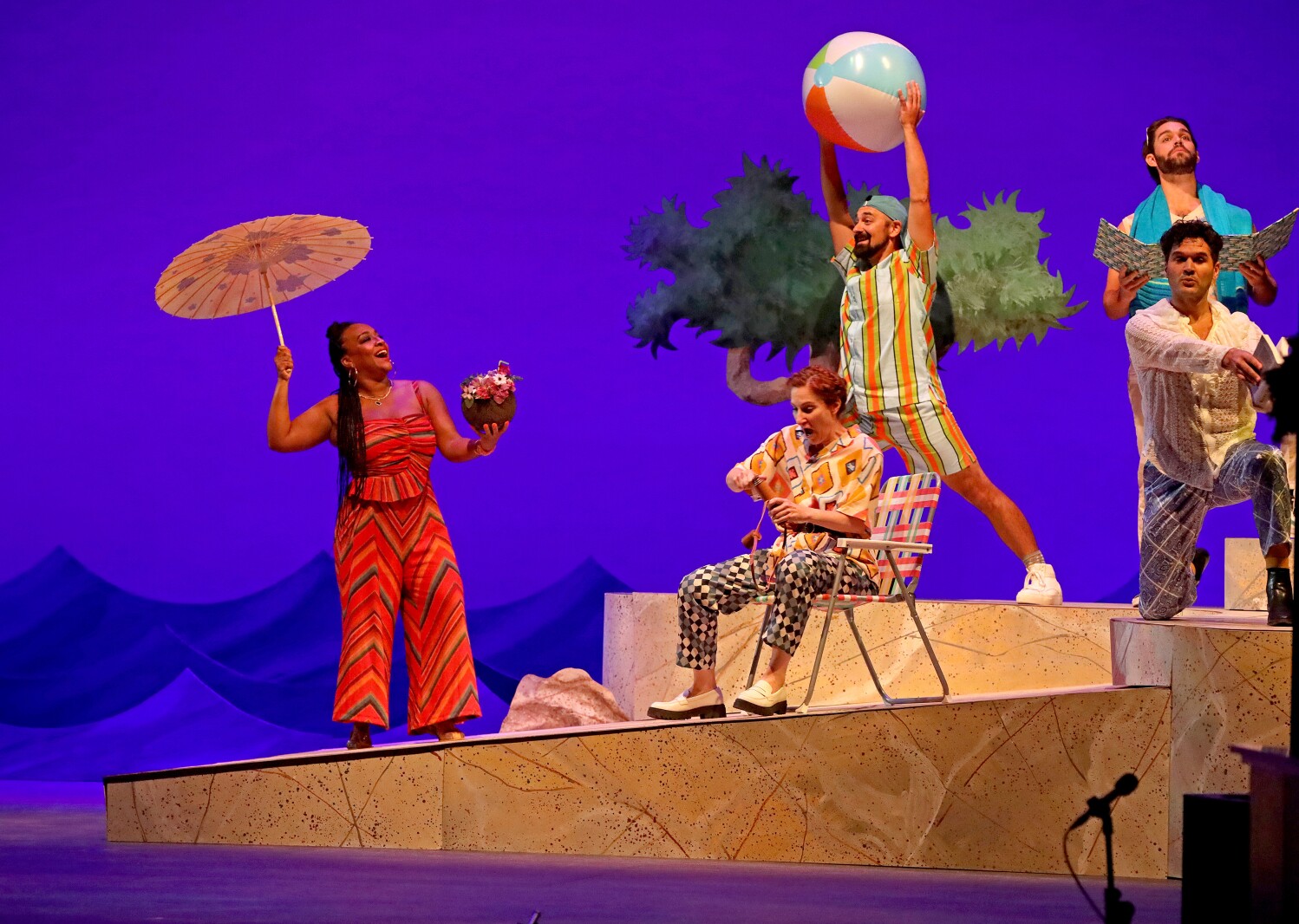 Actors perform on stage.
