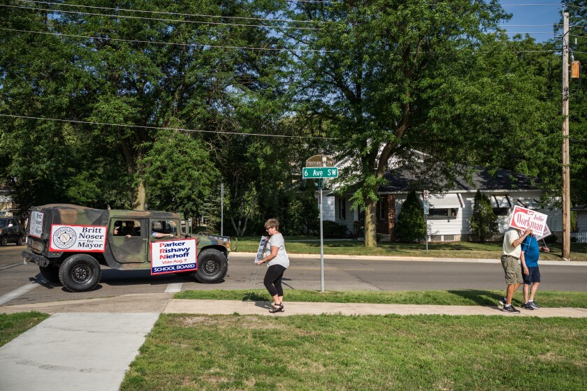 Photos Supporters for opposing school board candidates rally at the