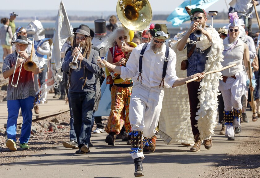 Morris dancer John Finkle and musicians from The Brass Messengers perform during Sunday’s “Run, Smelt, Run!” parade. Steve Kuchera / skuchera@duluthnews.com