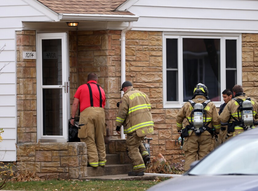 Firefighters from the Worthington Fire Department enter a home at 1014 McMillan Street Thursday, Nov. 3, 2022.