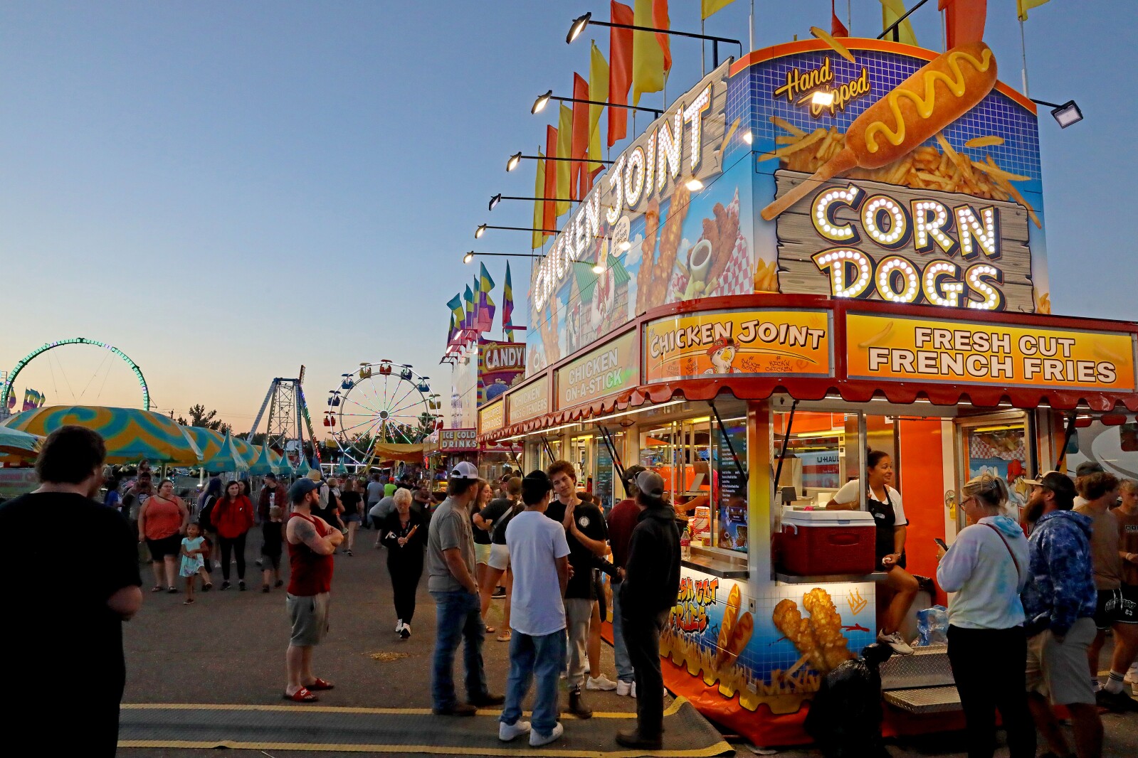 People enjoy the Crow Wing County Fair midway.