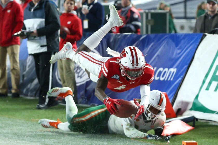 Rich Barnes / USA Today SportsBadgers wide receiver Aron Cruickshank (1) dives with the ball against the Miami Hurricanes during the fourth quarter of Thursday's Pinstripe Bowl at Yankee Stadium.