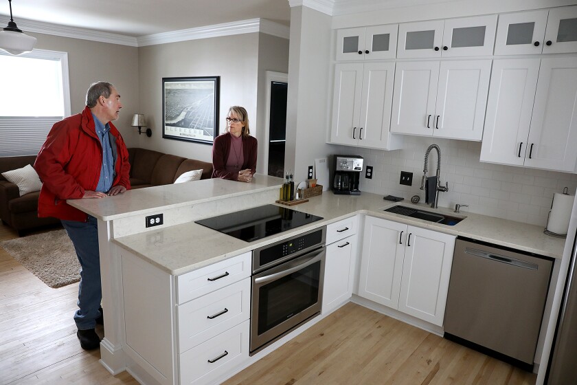 Biwabik Mayor Jim Weikum, left, chats with Tammy Schotzko in one of the renovated short-term rentals in the Green Gate Gasthaus