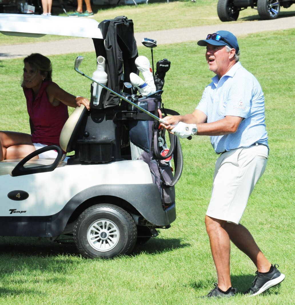 Thomas Albertson watches his pitch shot from the rough land near