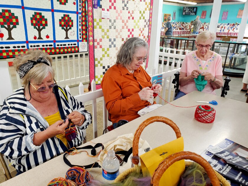 Three women knit and crochet
