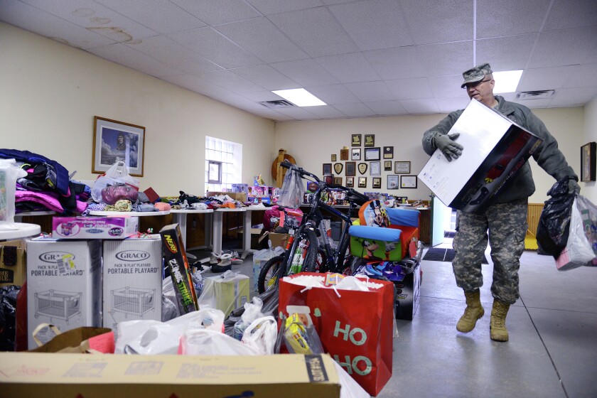 Camp Ripley soldiers deliver toys, clothes and other gifts to the Morrison County Gift Tag program in Little Falls. Photo by Staff Sgt. Anthony Housey