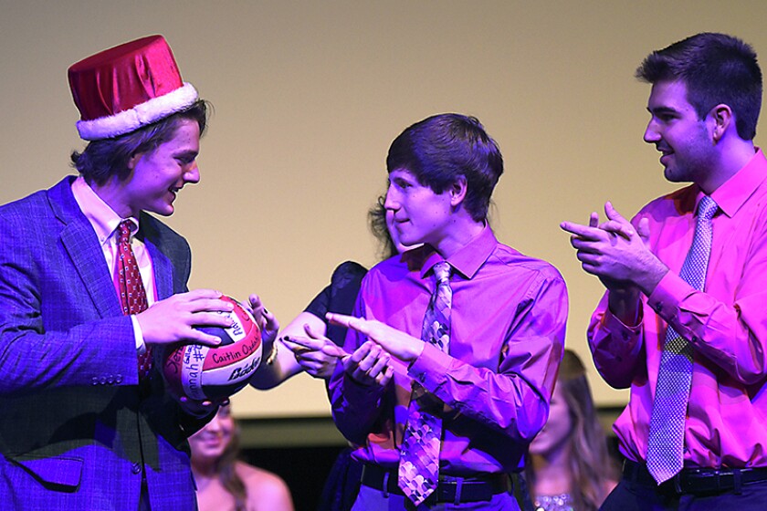 Briana Sanchez / TribuneChristian Grant Duininck takes a signed volleyball along with his crown Monday night at Willmar Senior High School. Duininck was named homecoming king.