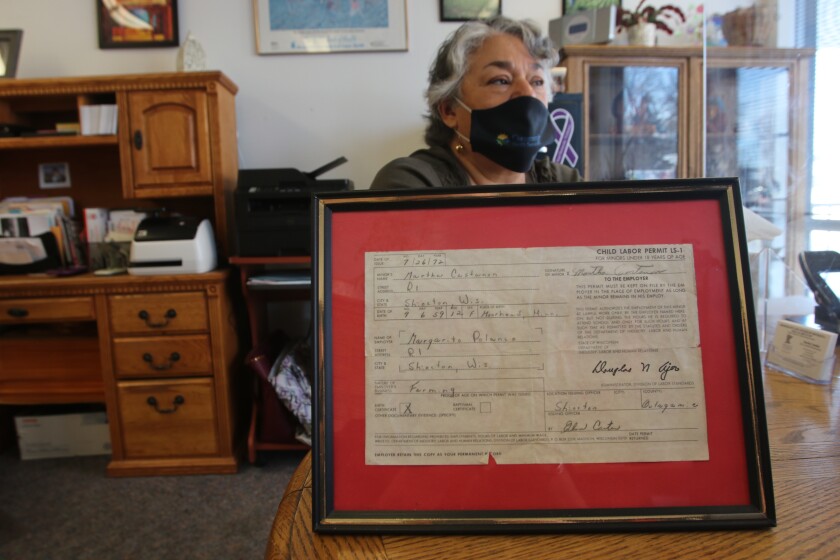 A tattered certificate is displayed in a frame.