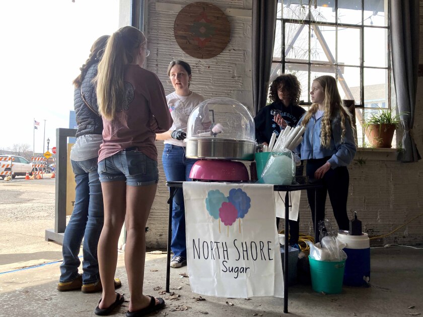 People at a candy booth during a business event.