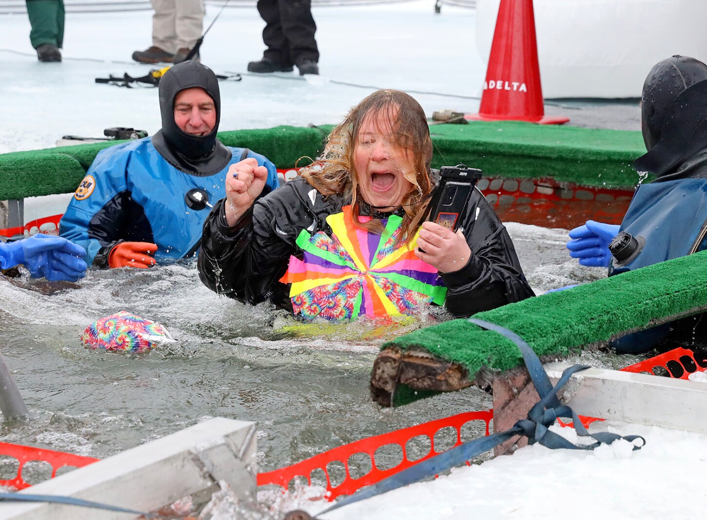 People jump into the water during the Polar Plunge event on Pelican Lake.
