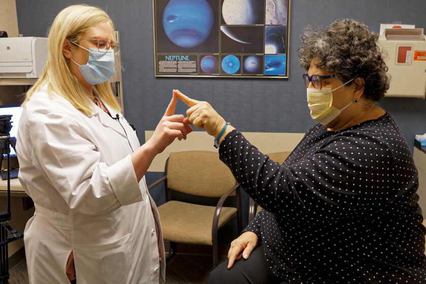 Dr. Tonya Harlow runs patient Terri Barta through a test