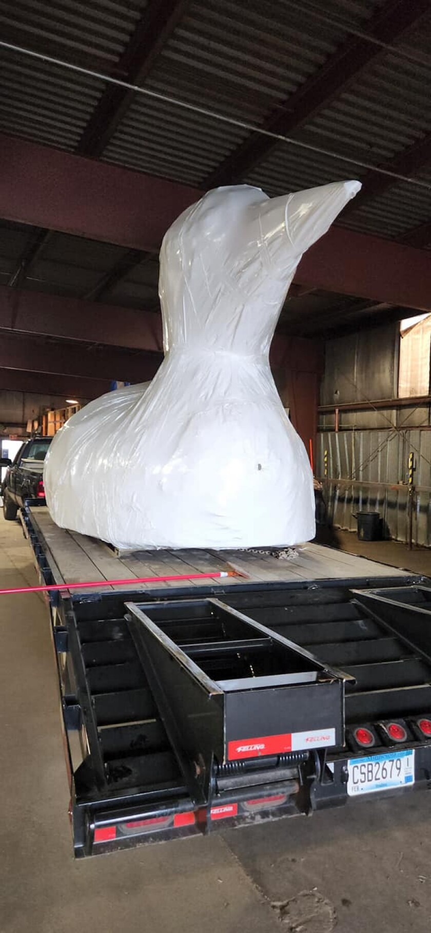 Photo of truck bed with giant loon model wrapped in white plastic