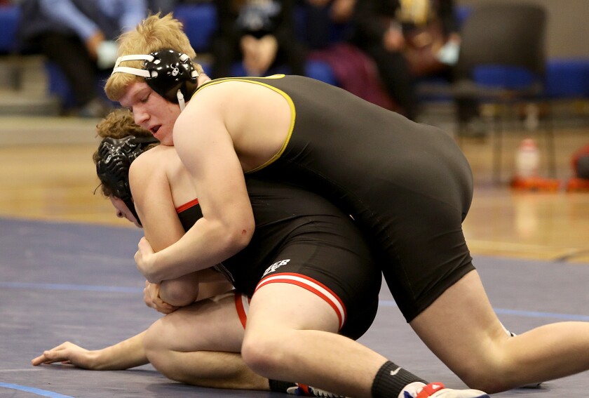 Northwestern’s Ian Smith, top, controls Bloomer-Colfax’ Brok McCann
