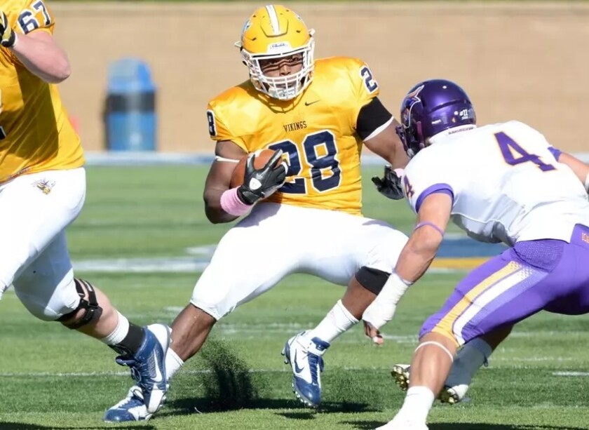 Augustana's C.J. Ham carries the ball while Minnesota State's Nathan Hancock attempts to make a tackle on Saturday, Oct. 25, 2014, at Kirkeby-Over Stadium in Sioux Falls.