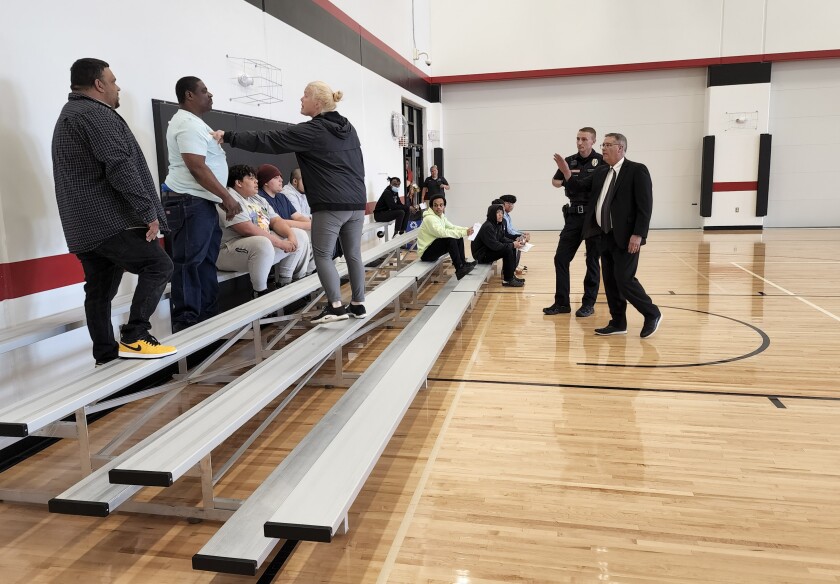 District 518 Superintendent John Landgaard and a Worthington Police officer approach a couple of individuals in the bleachers at the Learning Center graduation as a series of fights broke out.