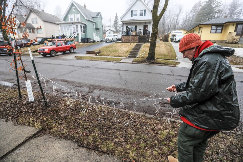 Community members gather to light the Barry home in the East Hillside neighborhood of Duluth