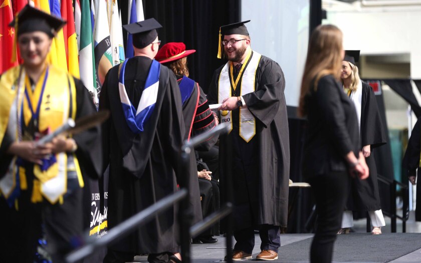 Graduate shakes hands with the Chancellor