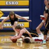 Players fight for loose ball on the ground.