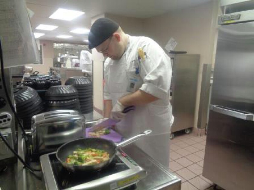 Cook Coordinator Sam Nesheim prepares a meal on the purple allergy station in the kitchen at Essentia Health-St. Joseph's Medical Center. Submitted Photo