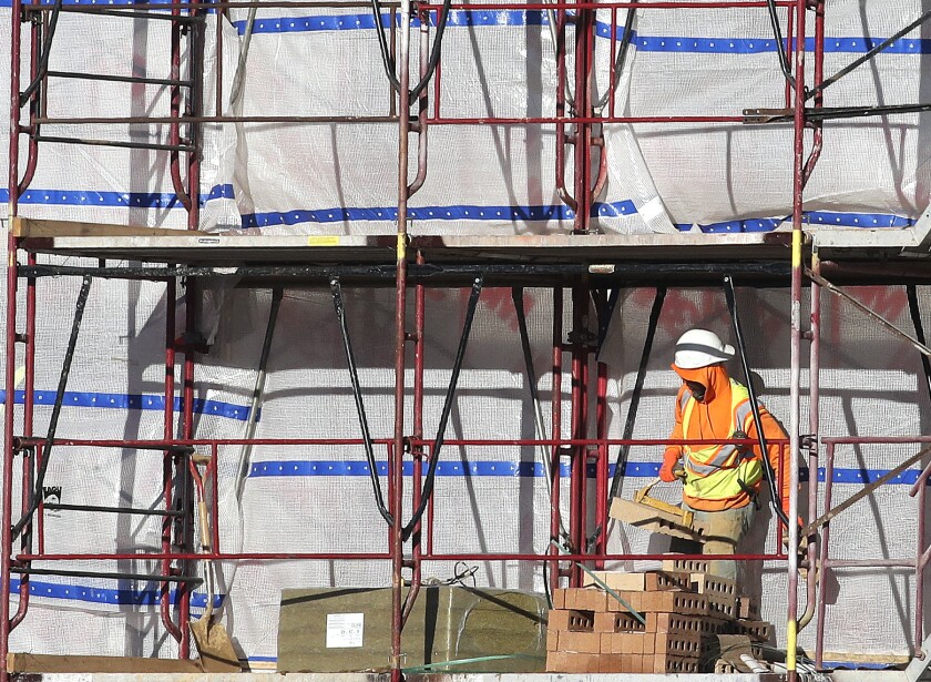 A man works on scaffolding.