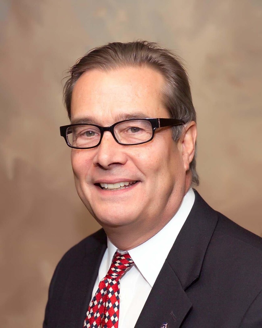 Doug Hamilton is shown with his hair combed back and smiling