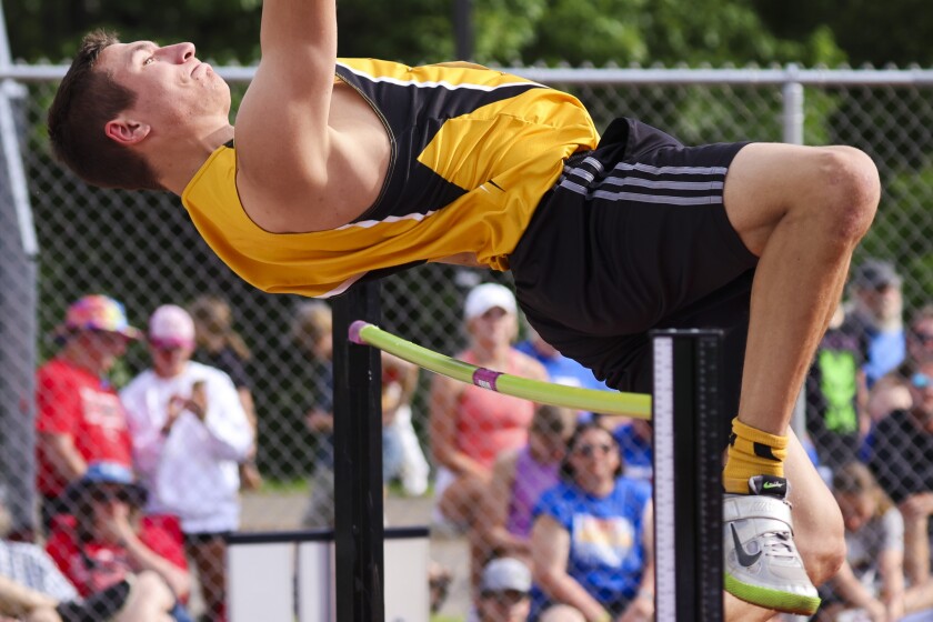 Athletes compete in track and field events at outdoor stadium