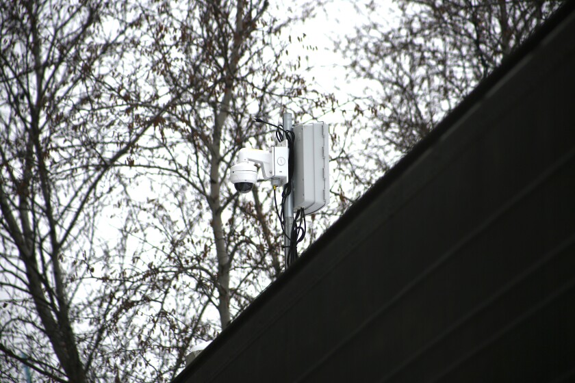 Security camera sits up high.
