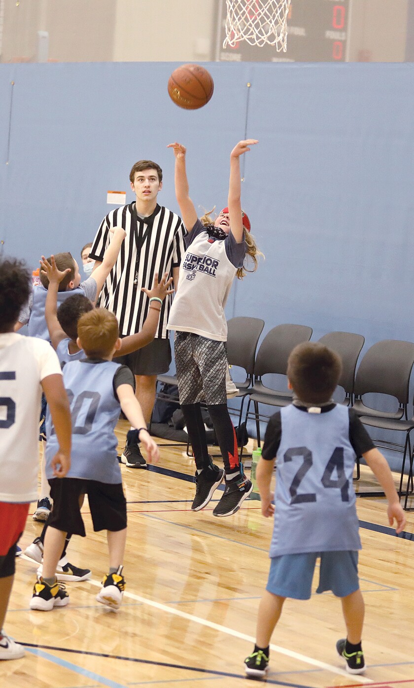 Robert Olson, a senior captain on the Superior High School basketball team, watches the action of a Superior Basketball Association Mini-Ballers game