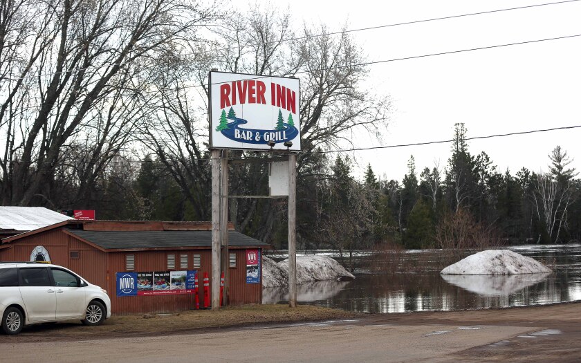 A restaurant with flooding nearby.
