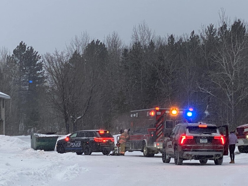 ambulance and police cars at fire scene