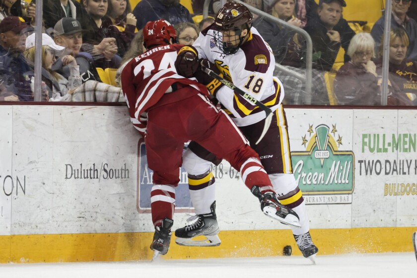 college hockey players play ice hockey