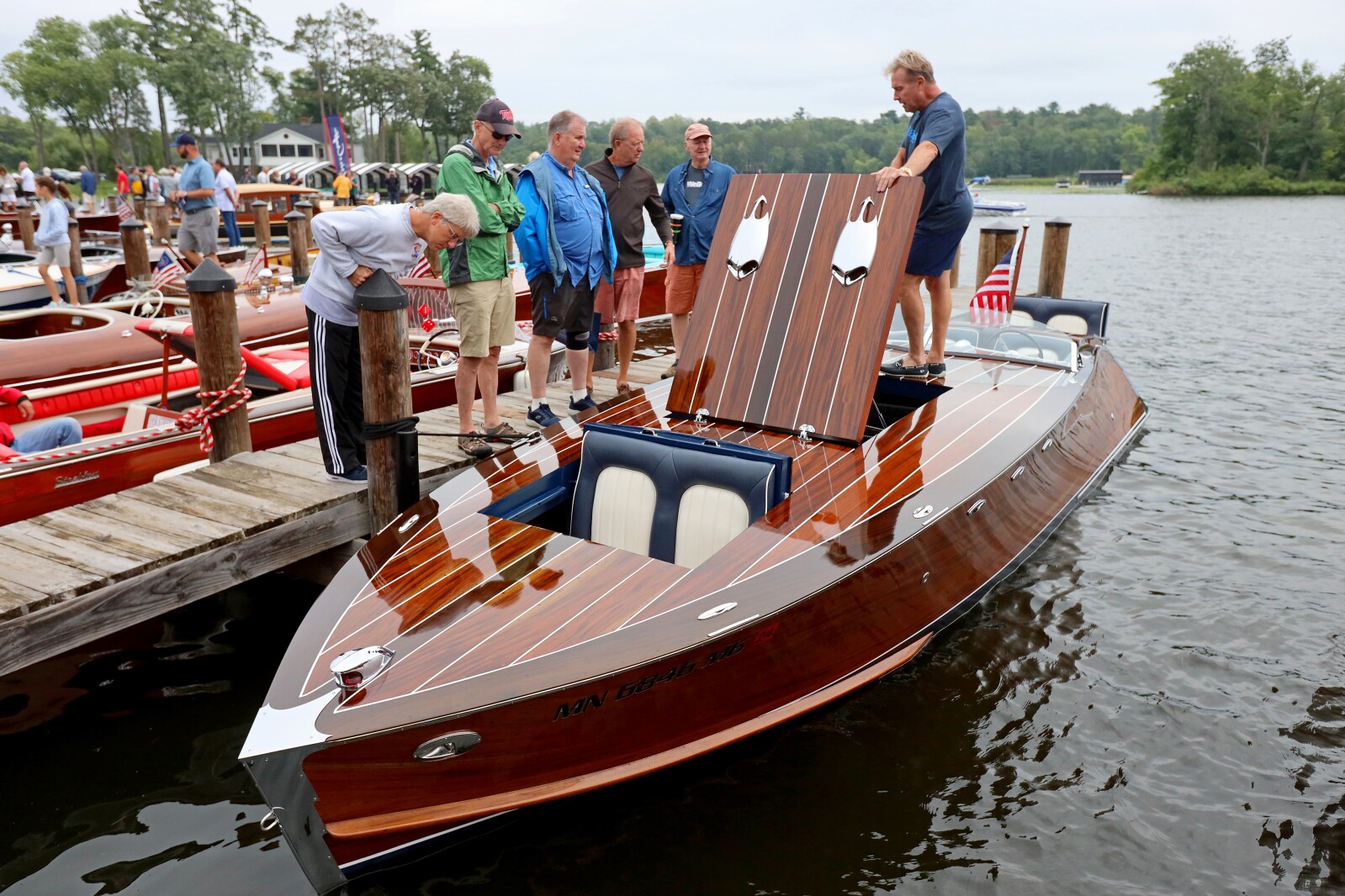 Attendees admire classic boats on display Saturday, Aug. 27, 2022, during the annual Classic Boat Show at the Bar Harbor Supper Club in Lake Shore.