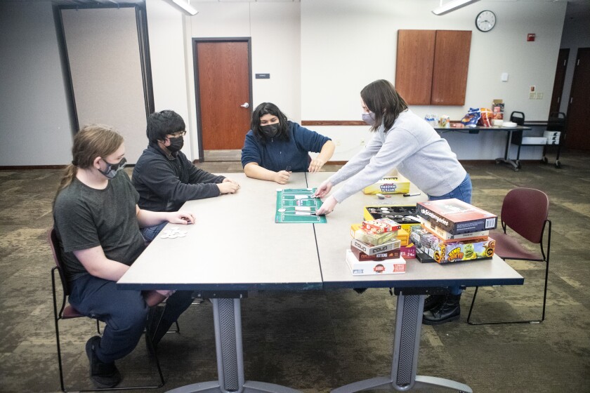 Teen Programming Librarian Samantha Lilienthal, at right, sets up the board for Wits and Wagers during a Teen Gaming Club gathering at the Willmar Public Library Friday, Feb. 11, 2022.