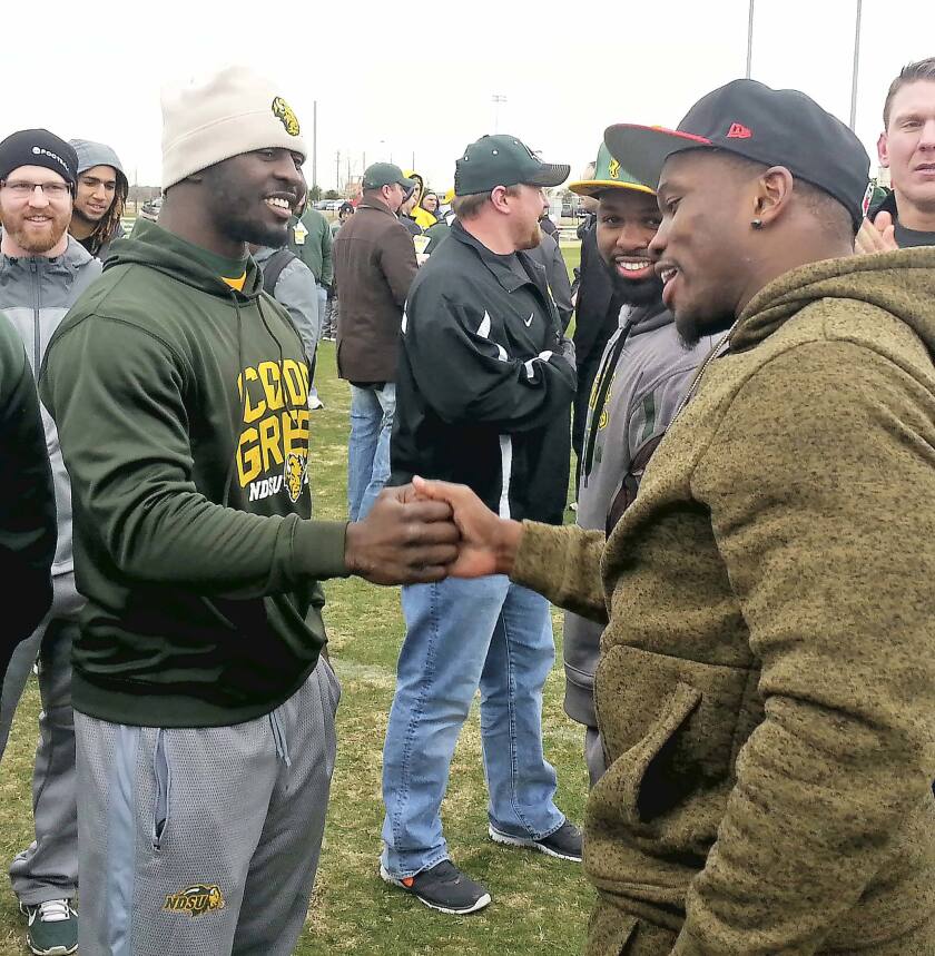 Carlton Littlejohn greets Kansas City's Joe Mays