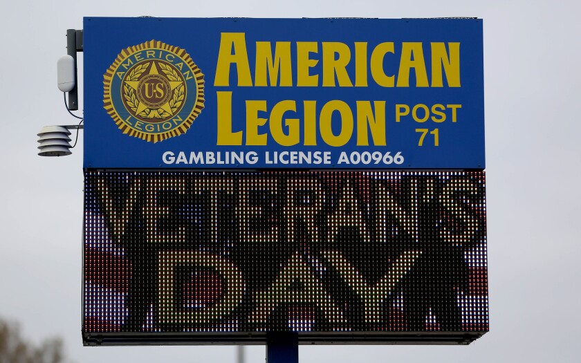 A sign for an American Legion Post with a lighted display for Veterans Day