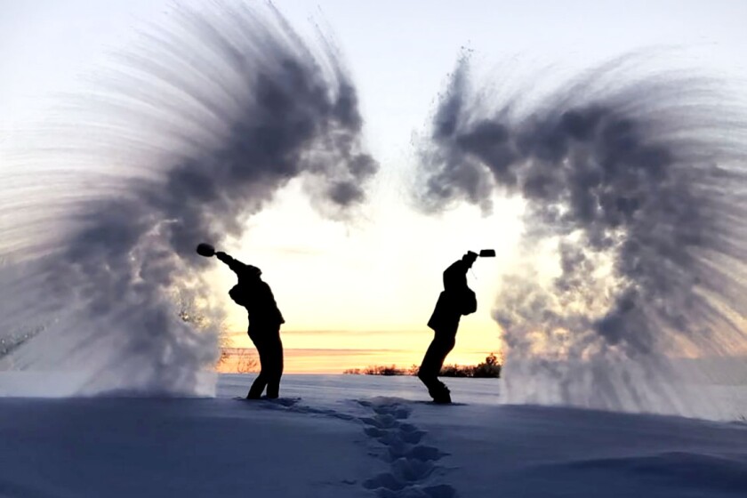 Throwing hot water on cold day