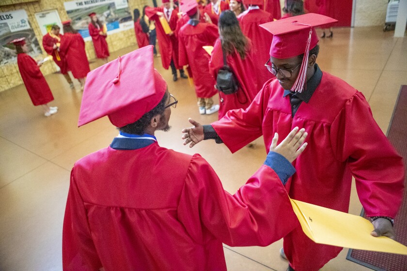 Abdumalik Salah, from left, and Adnan Hassan celebrate together after the Willmar High School Class of 2022 concluded its commencement ceremony at the Willmar Civic Center on Sunday, June 5, 2022.