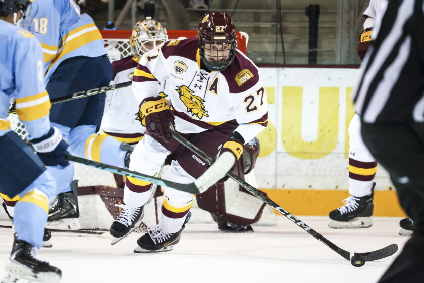 college men play ice hockey indoors