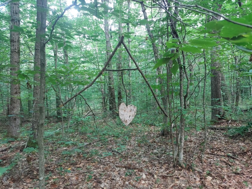 Wooden "AT" sign with heart at the bottom.