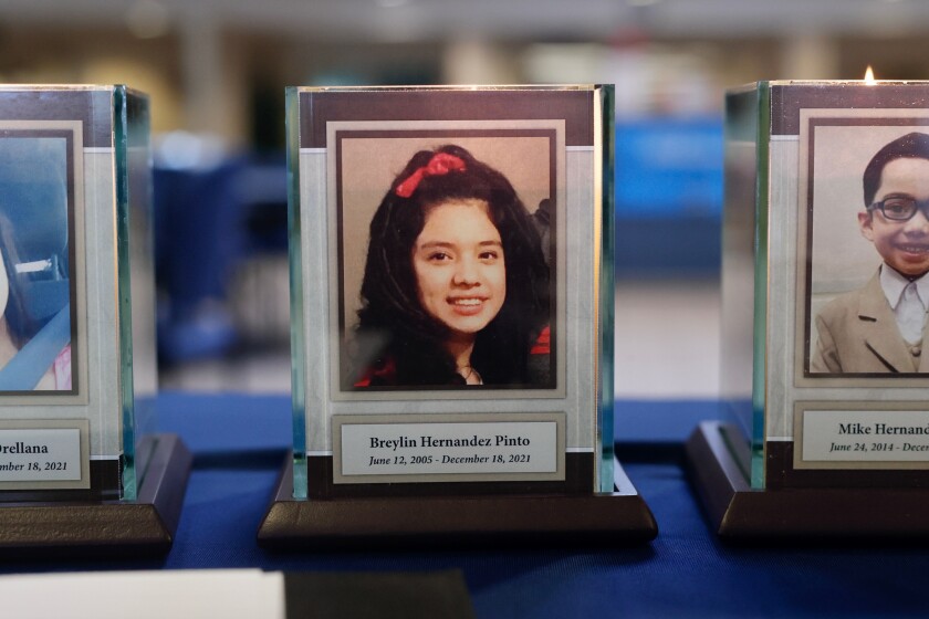 A plaque and candle with a portrait of Breylin Hernandez Pinto.