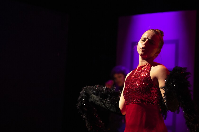 Miss Scarlet, played by actress Rachel Trettin, is introduced to the audience at the start of the performance as a dress rehearsal of "Clue: The Musical" at the Barn Theatre is held Thursday, March 24, 2022.