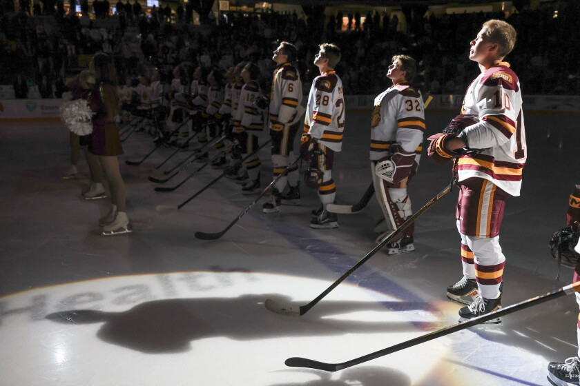 college men play ice hockey indoors