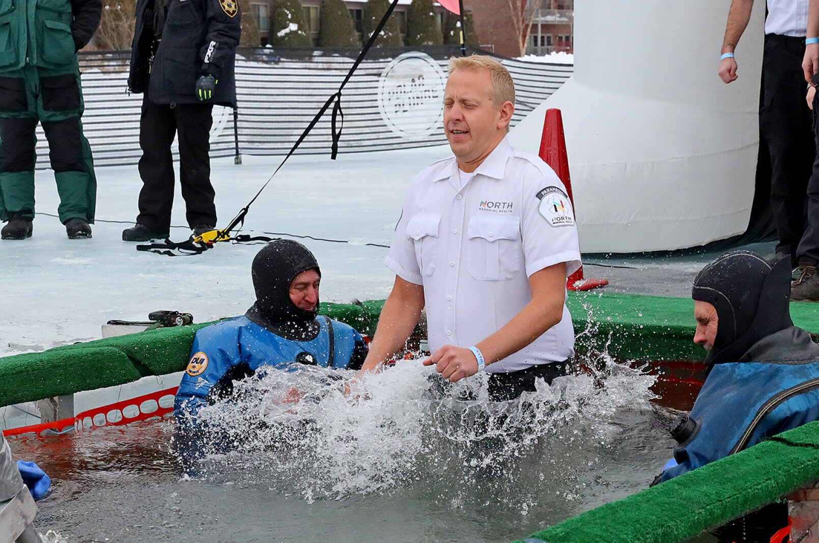 People jump into the water during the Polar Plunge event on Pelican Lake.