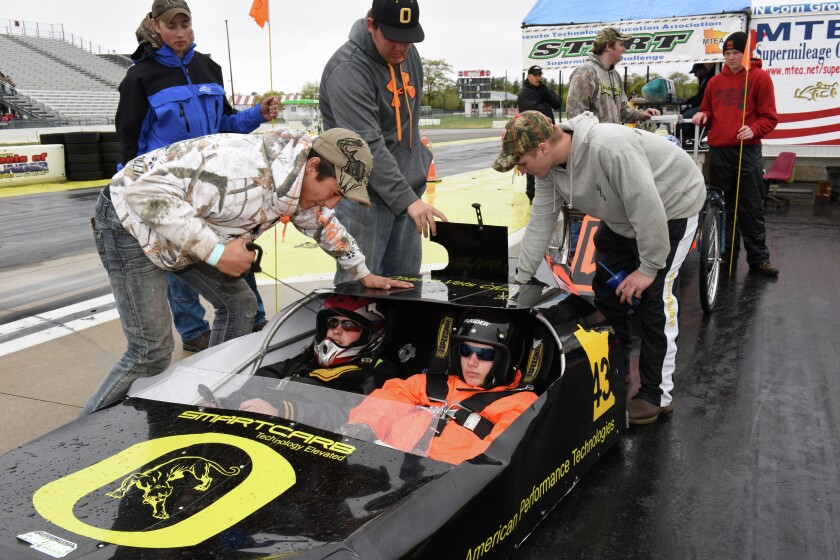 Onamia High School team member Ben Fetters (left) starts the high-mileage vehicle with Alex Logli and Austin Stark behind the wheel ready to drive Monday at Brainerd International Raceway. The school was one of 65 teams in the Minnesota Technology and Engineering Education Association Supermileage Competition. The event continues through today. Video and Gallery