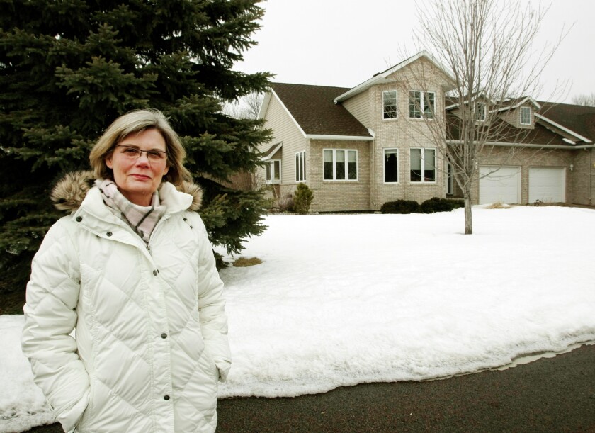 Jo Ann Miller stands outside her home at Orchard Park Drive